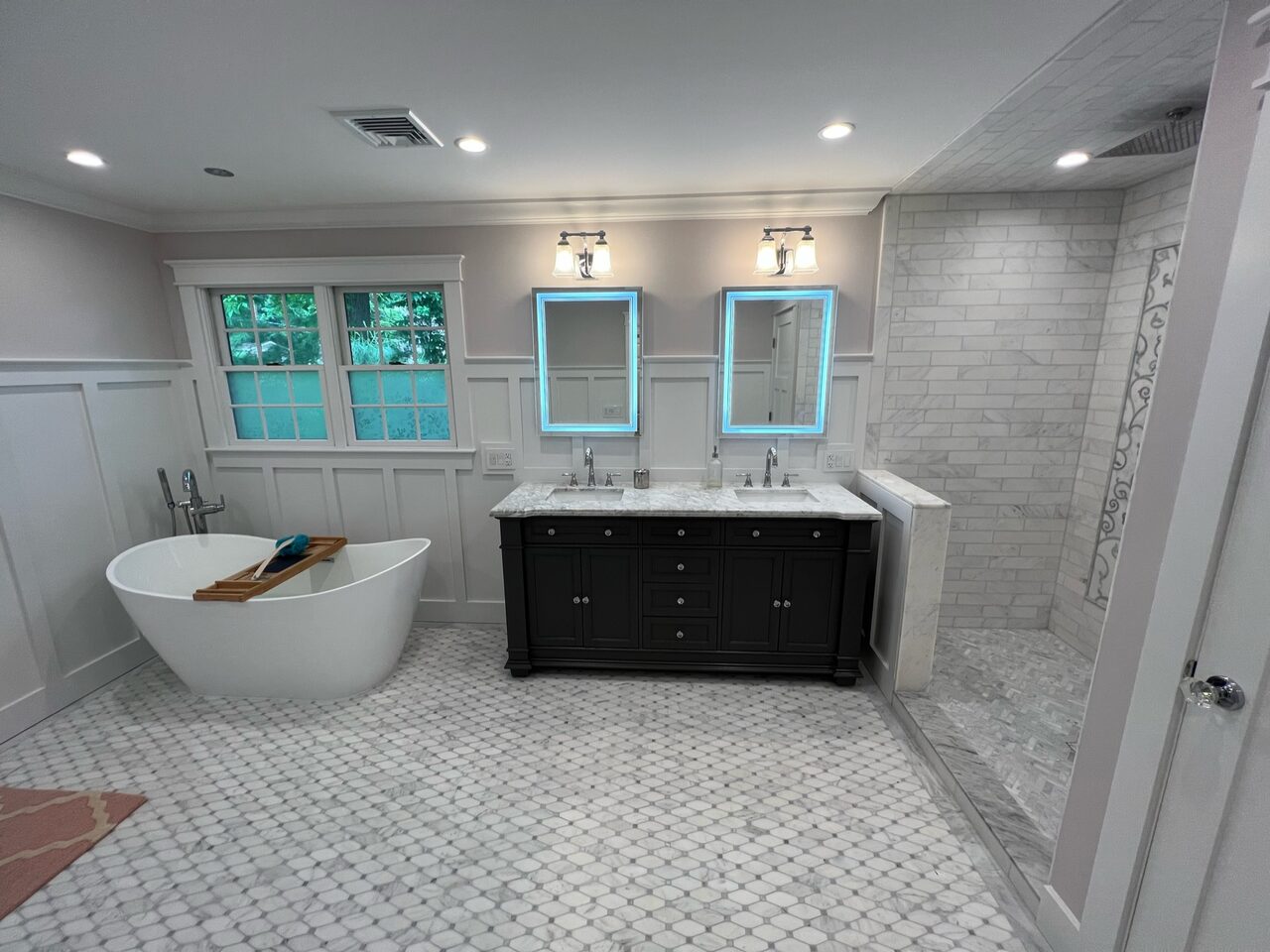 Master bathroom with freestanding tub between double vanities