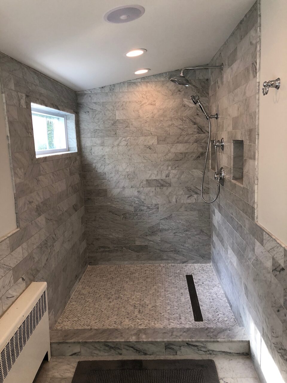 Marble walk-in shower with bench