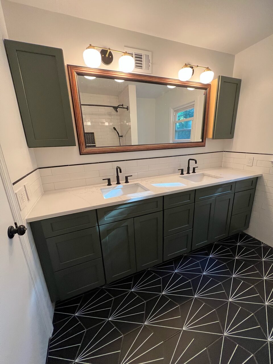 Double vanity bathroom with patterned tile floor