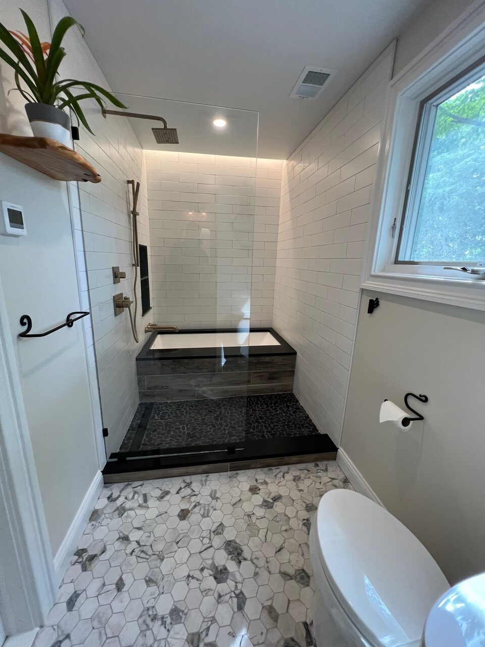Spa bathroom with skylight and soaking tub